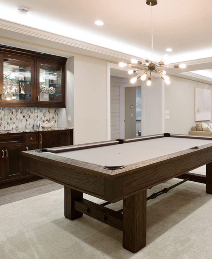 Beautiful basement entertaining room with LED lighting in tray ceiling, billiards table with kitchenette