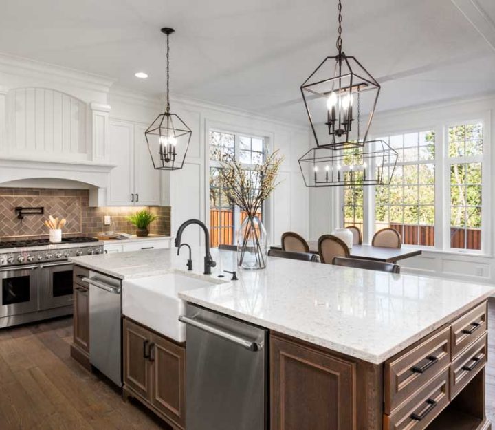 Beautiful kitchen in new traditional style luxury home, with quartz counters, hardwood floors, and stainless steel appliances